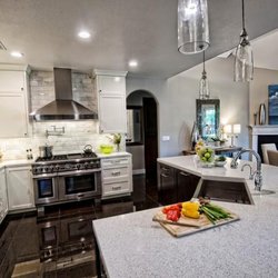 TREND Transformations of Maplewood - Gorgeous Dove Tail recycled glass countertops pair beautifully with white shaker cabinets to create an inviting kitchen vibe.