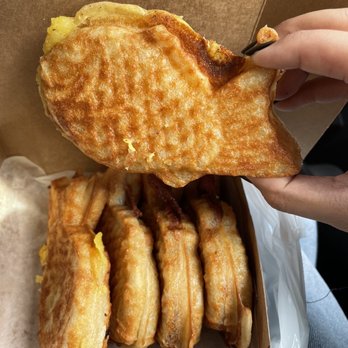 Kevin's Taiyaki - a hand holding a half eaten sandwich - Specialty Food Near Me - Toronto, Ontario