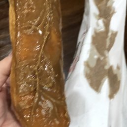 Maple bar with half the maple still stuck to the bag.