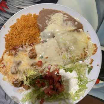 Laredo Mexican Restaurant - El Jefe burrito with rice and beans. All the sauce was on the left side as pictured. - Mexican Near Me - Starke, Florida