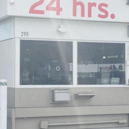 the front of a 24 hrs store the front of a 24 hrs store