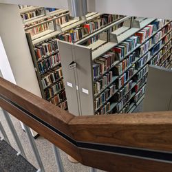 Manchester University - View from a floor up of library stacks.