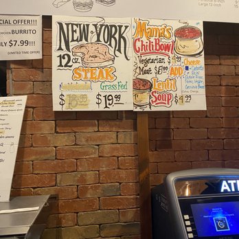 Caveman Cafe - menus on a brick wall - Organic Stores Near Me - Vancouver, British Columbia