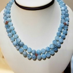 Nando's Jewelers - Hand beaded aquamarine necklace with yellow gold accents that are set with pink and blue topaz
