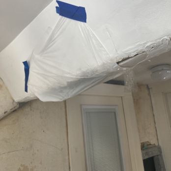 George's Painting Services MA - Water damage from a leak in the roof covered by a trash bag - Painters Near Me