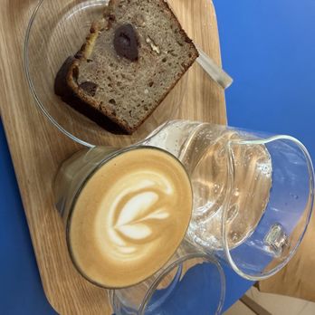 SlowMov - Flat White, banana bread, and sparkling water - Coffee Roasteries Near Me - Barcelona, B SlowMov - Flat White, banana bread, and sparkling water - Coffee Roasteries Near Me - Barcelona, B