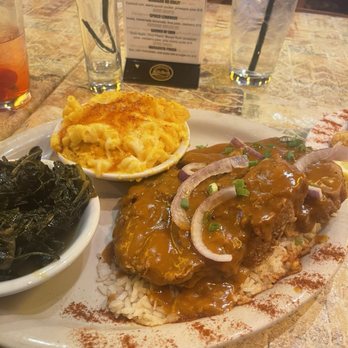 Carolina Kitchen Bar & Grill - Smothered Southern Fried Pork Chops, Mac and cheese and greens over white rice - Soul Food Near Me - Hyattsville, Maryland