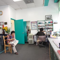K M Cleaners - tailors at work