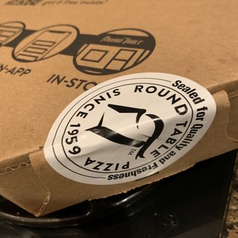 Round Table Pizza - a box of pizza sitting on top of a stove - Pizza Near Me - San Diego, California Round Table Pizza - a box of pizza sitting on top of a stove - Pizza Near Me - San Diego, California