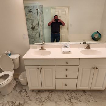 Beach House Construction - a man taking a selfie in the bathroom - General Contractors Near Me Beach House Construction - a man taking a selfie in the bathroom - General Contractors Near Me