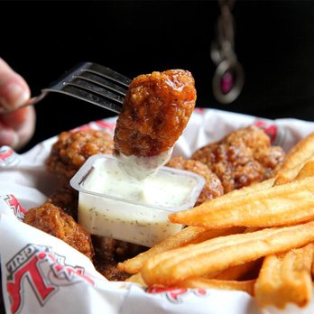 St. Louis Bar & Grill - a fork lifting a piece of fried chicken - Sports Bars Near Me - Wasaga Beach, Ontario St. Louis Bar & Grill - a fork lifting a piece of fried chicken - Sports Bars Near Me - Wasaga Beach, Ontario