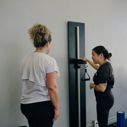 Thrive Fit - A coach takes a member's body composition reading at the start of a Body Reset Baseline.