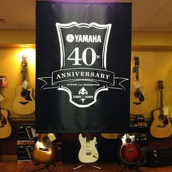 Rick's Musical Instruments - Yamaha 40th anniversary photo being celebrated in our showroom!