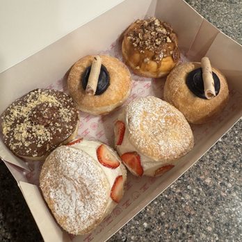 Chubby Baker - (Top row, left to right) Ferrero Rocher, Ube, Sticky date  Bottom row, left to right) strawberry and cream, ube - Donuts Near Me - Sandy, Utah