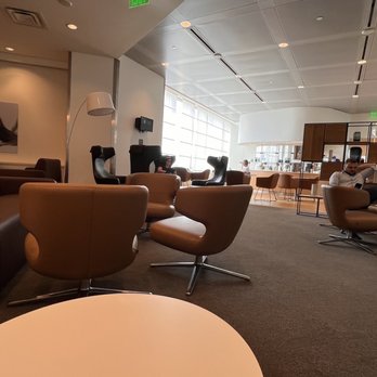 Lufthansa Senator Lounge - a man sitting in a chair - Airport Lounges Near Me - Detroit, Michigan