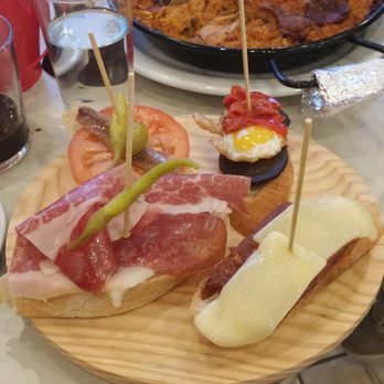 Olé Tapas - Pinxtos, sardine, iberico ham, chorizo spread with melted cheese and quail egg with vegetables - Tapas Bars Near Me - Sainte-Anne-de-Bellevue, Quebec Olé Tapas - Pinxtos, sardine, iberico ham, chorizo spread with melted cheese and quail egg with vegetables - Tapas Bars Near Me - Sainte-Anne-de-Bellevue, Quebec