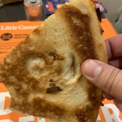 Little Caesars Pizza - Pizza with sticker on back of half-eaten slice. Disgusting!