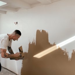 Erik creating a Venetian plaster feature wall in my garage. He also put up the skylights above.