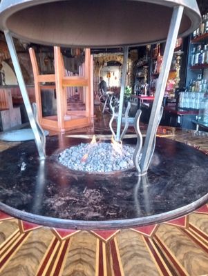 Bar fire pit - A firepit installed into a bar table with remote control Bar fire pit - A firepit installed into a bar table with remote control