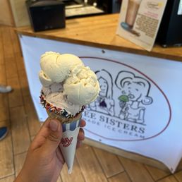 Medium sized strawberry ice cream , vanilla ice cream , chocolate sprinkle waffle cone Medium sized strawberry ice cream , vanilla ice cream , chocolate sprinkle waffle cone
