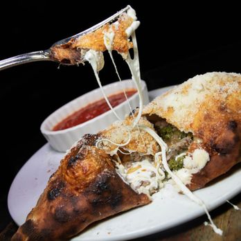 Fornino- Greenpoint - a piece of pizza with cheese and sauce - Pizza Near Me - Brooklyn, New York Fornino- Greenpoint - a piece of pizza with cheese and sauce - Pizza Near Me - Brooklyn, New York
