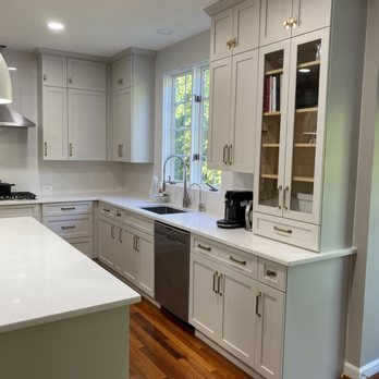 Prime Custom - a kitchen with white cabinets and wood floors - General Contractors Near Me - Sterling, Virginia