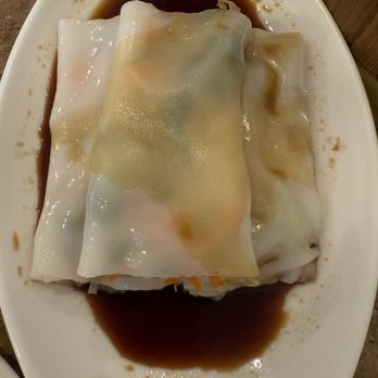 Dim Sum Kitchen - Rice noodle rolls with soy sauce served on a white plate, typical of Chinese dim sum cuisine. - Dim Sum Near Me - Bradenton, Florida