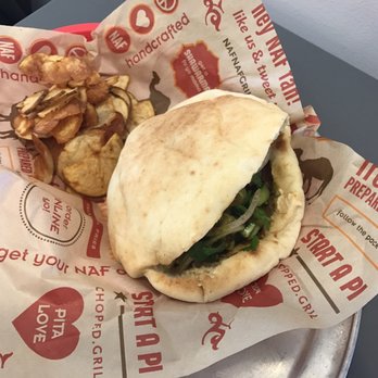 Naf Naf Grill - Pita with Hummus, chicken shawarma, chopped salad, sumac onions and S'khug sauce - Middle Eastern Near Me - Independence, Ohio Naf Naf Grill - Pita with Hummus, chicken shawarma, chopped salad, sumac onions and S'khug sauce - Middle Eastern Near Me - Independence, Ohio