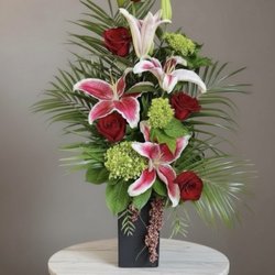 Eufloria Florist - Evermore - red roses, Stargazer lilies, green hydrangea and tropical greenery in a dramatic modern arrangement.