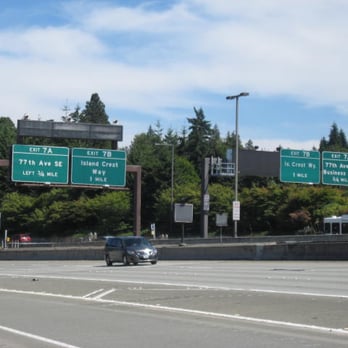 I-90 Floating Bridge - Looking back at Mercer Island as I-90 approaches the Lid and the freeway exits shown on the green signs. - Landmarks & Historical Buildings Near Me - Seattle, Washington