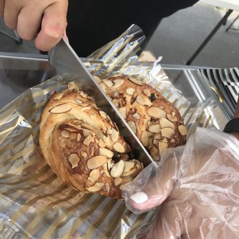 Petite Astorias - Ashley cutting our chocolate almond croissant - Desserts Near Me Petite Astorias - Ashley cutting our chocolate almond croissant - Desserts Near Me