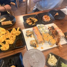 Our first round with a vegas roll (so delicious) California, spicy yellowtail, TNT roll, sliced salmon appetizer on the right side