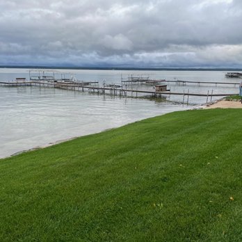Northern Landscape - a man standing on a dock on a lake - Landscaping Near Me Northern Landscape - a man standing on a dock on a lake - Landscaping Near Me