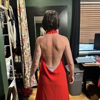 Kaya Bridal - A person in a red dress too big in a green room with their back turned towards the camera - Sewing & Alterations Near Me - Irvine, California Kaya Bridal - A person in a red dress too big in a green room with their back turned towards the camera - Sewing & Alterations Near Me - Irvine, California