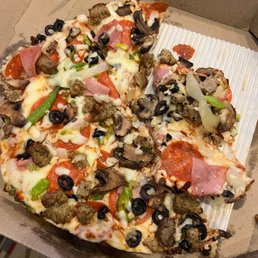 Undercooked supreme pizza