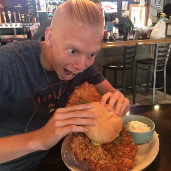 The Blind Pig - My son attacking the pork loin sandwich.  The sandwich won. - Sports Bars Near Me - Cedar Rapids, Iowa