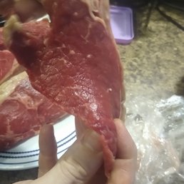 a person holding a piece of meat a person holding a piece of meat