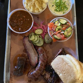 Interstellar BBQ - Beans, mac n cheese, tomato zucchini salad, creamed corn, peach tea glazed pork belly, jalapeño popper sausage, and pork spare ribs - Barbeque Near Me - Austin, Texas