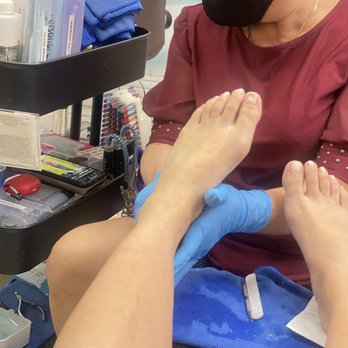 Diva Nails - Worker watching a movie on her phone while she does my pedicure - Nail Salons Near Me - Chula Vista, California