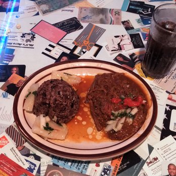 Numero Uno Cuban Restaurant - This is an aerial view of the table (notice all the business cards?) with the ropa vieja platter and a soft drink. - Cuban Near Me - Orlando, Florida Numero Uno Cuban Restaurant - This is an aerial view of the table (notice all the business cards?) with the ropa vieja platter and a soft drink. - Cuban Near Me - Orlando, Florida