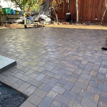Tran's Landscaping - a brick patio with steps leading up to it - Landscaping Near Me