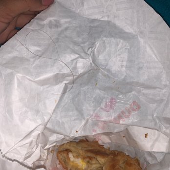 Dunkin' -  a half eaten sandwich in a wrapper - Donuts Near Me - Owings Mills, Maryland