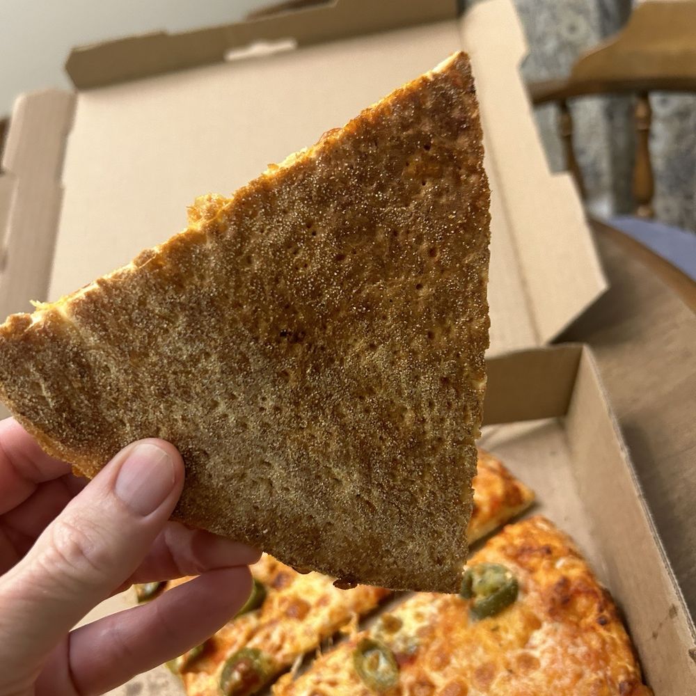 Stoner's Pizza Joint - Under side of pizza - Pizza Near Me - Palm Coast, Florida Stoner's Pizza Joint - Under side of pizza - Pizza Near Me - Palm Coast, Florida