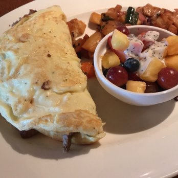 Winewood - Steak omelette with potatoes and fruit. The poppyseed yogurt sauce is amazing. - New American Near Me - Grapevine, Texas