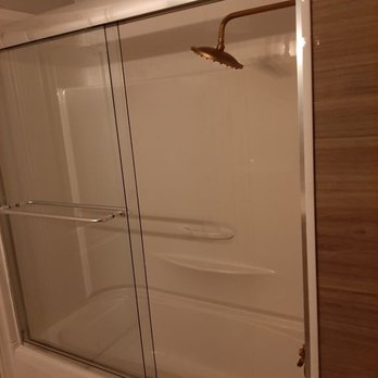 Custom Fix Renovations - a shower with a glass door - General Contractors Near Me