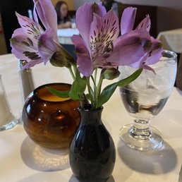 All of the tables have fresh flowers All of the tables have fresh flowers
