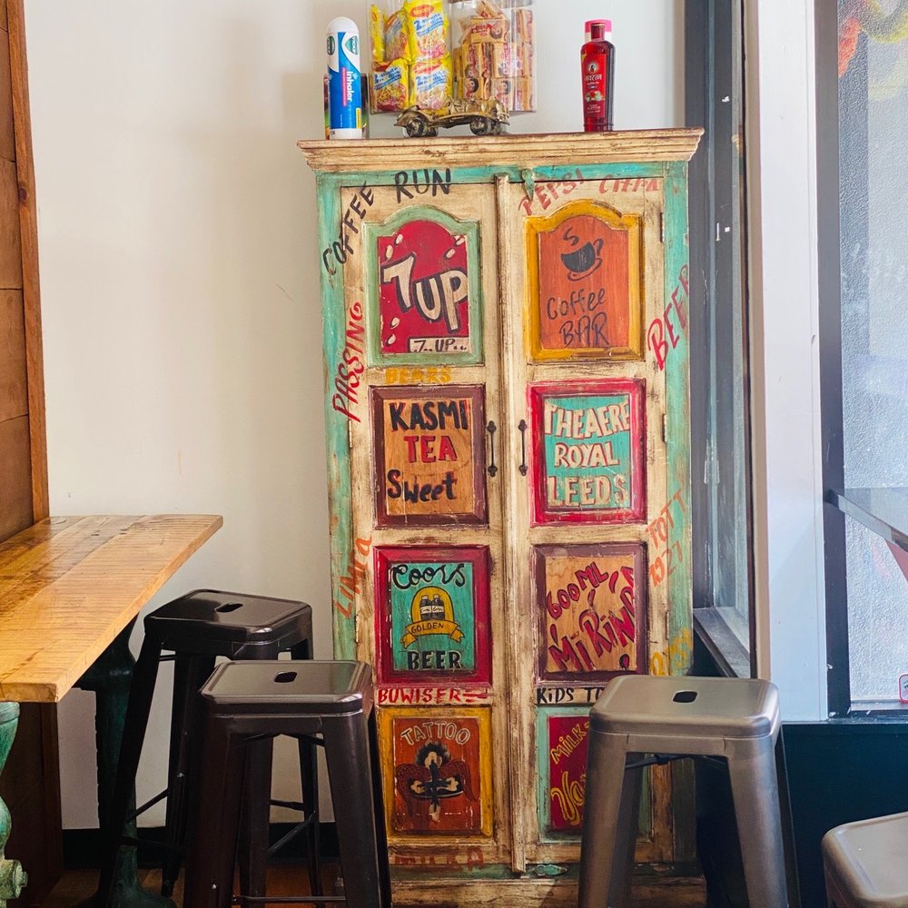 a colorful cabinet in the corner of a room a colorful cabinet in the corner of a room