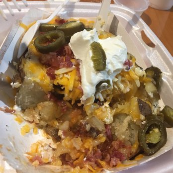 Brannan Schlitz BBQ - HUGE Brisket stuffed baked potato with cheese, bacon, butter, sour cream and jalapeños! For under $8.  This is the remaining half - Barbeque Near Me - Sanford, North Carolina