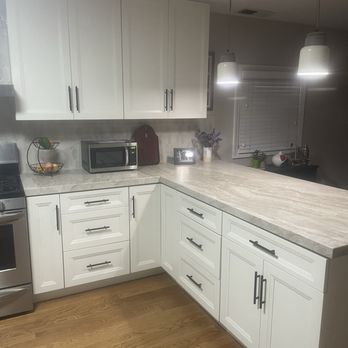 Gold Remodeling - Taj Mahal quartzite countertop, new white cabinets and hardwood floor. - General Contractors Near Me - Lafayette, California
