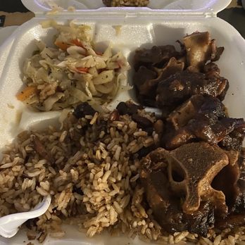 Sunshine Jamaican Restaurant - Small oxtail meal. At the top of the tray is rotten mushed plantain. - Caribbean Near Me - Stone Mountain, Georgia Sunshine Jamaican Restaurant - Small oxtail meal. At the top of the tray is rotten mushed plantain. - Caribbean Near Me - Stone Mountain, Georgia
